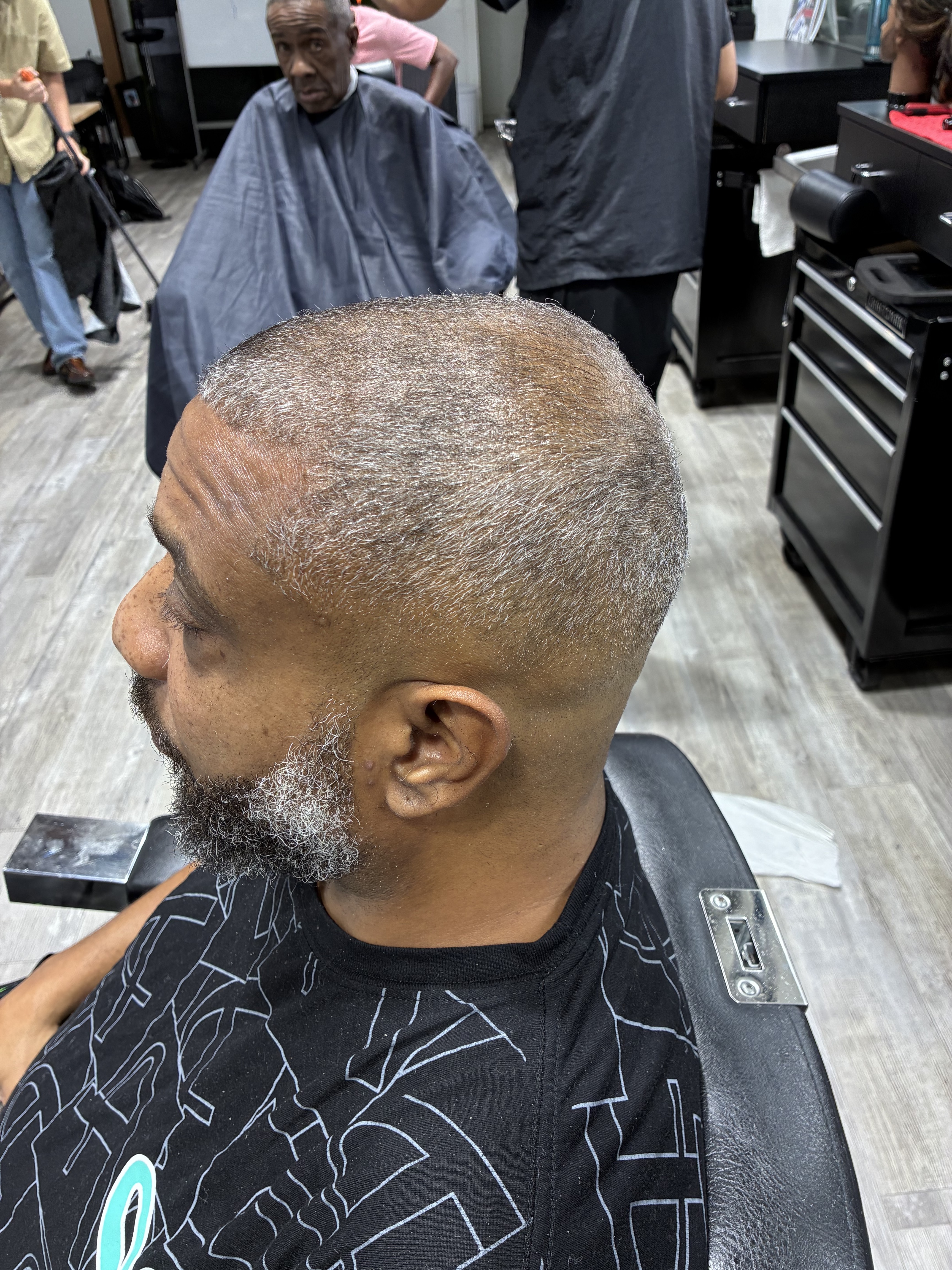Clean gray buzz cut and beard